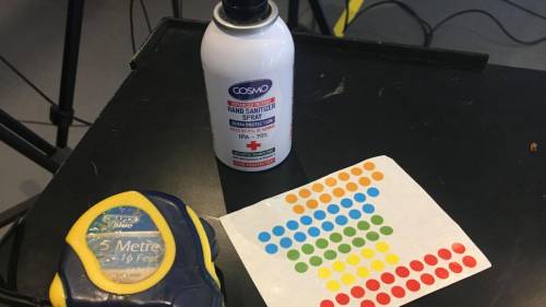 lockdown filming Table with a measuring tape, some sticky dots and a bottle of glue